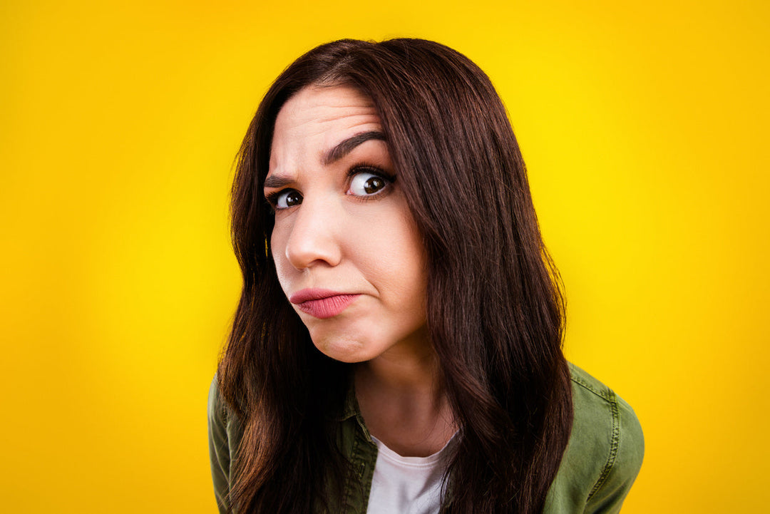woman looking curious on yellow background