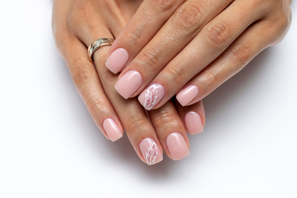 Manicured hands with light pink builder gel 
