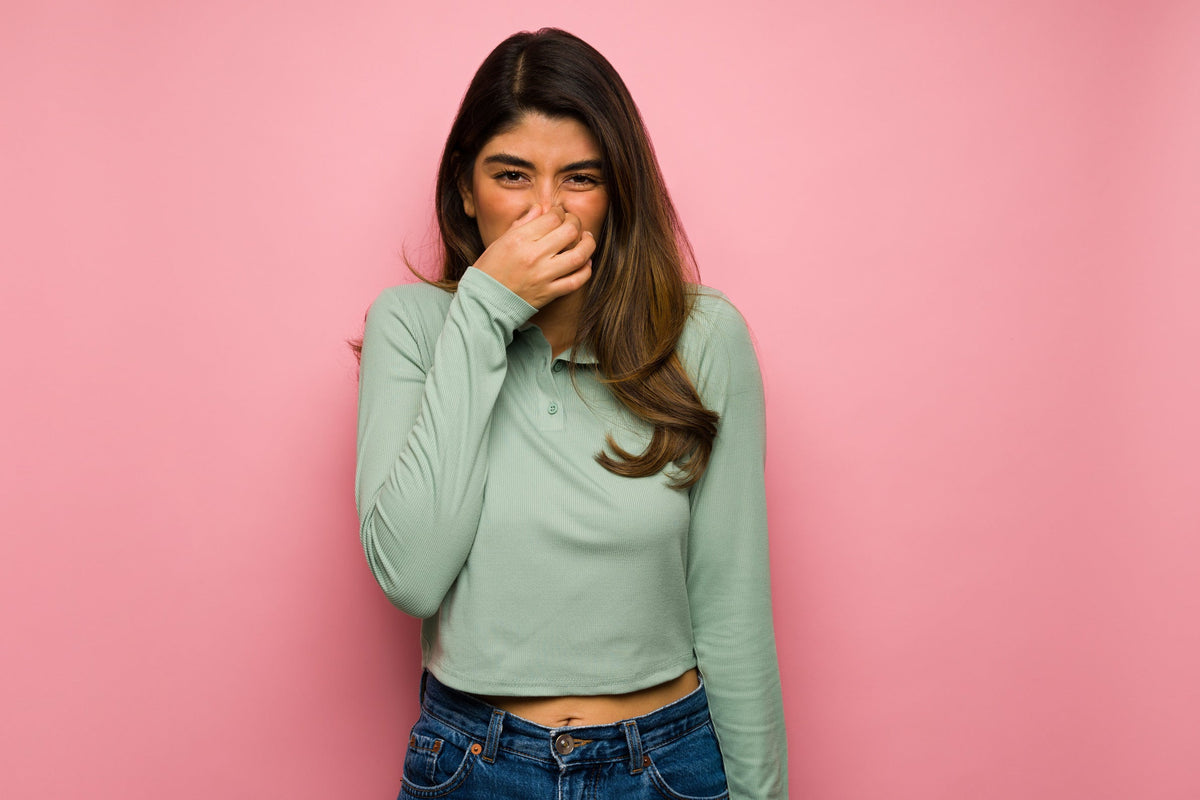 Woman smelling something bad