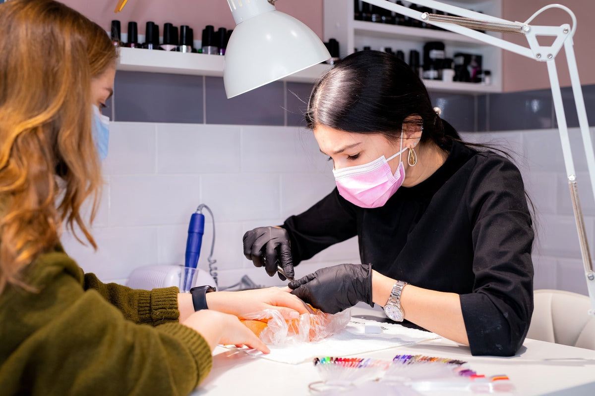 girl doing manicure on client