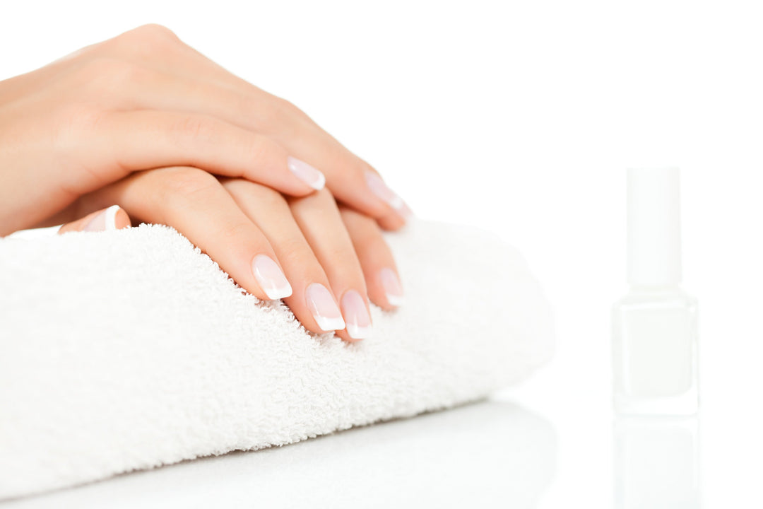 Gel Nail Polish on a woman's nails, resting on a towel
