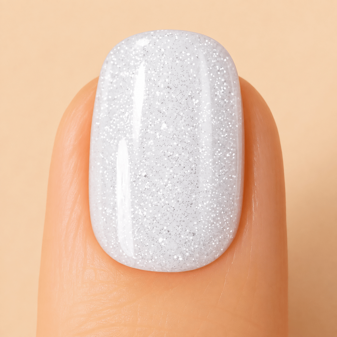 Angel Kiss white glitter gel nail polish on a nail.