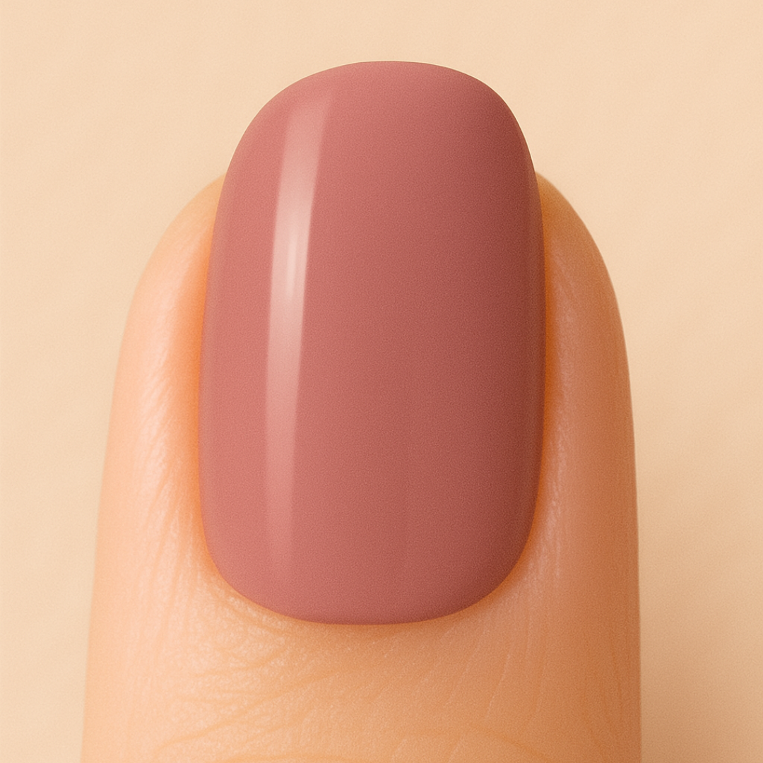 Light-brown gel nail polish colour on a nail against a beige background