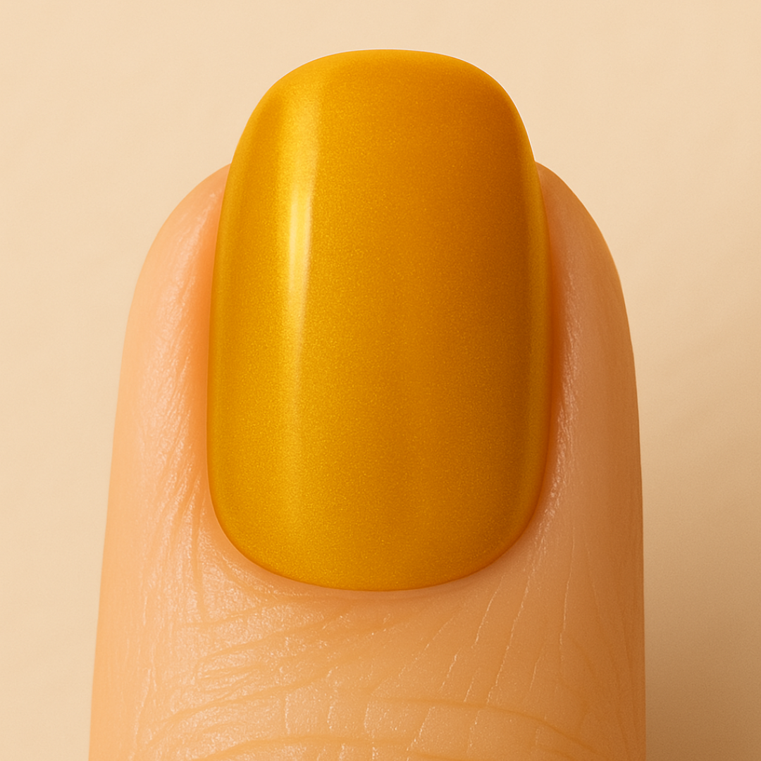 Yellow gel nail polish on a finger with a beige background