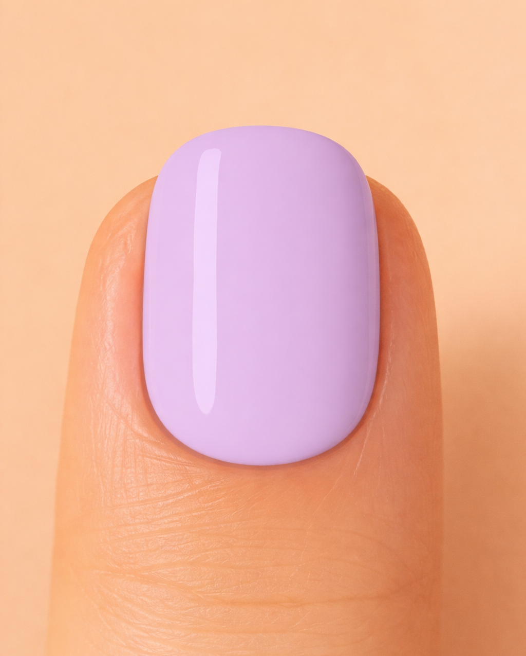 Close-up of a finger with a light purple nail on a peach background