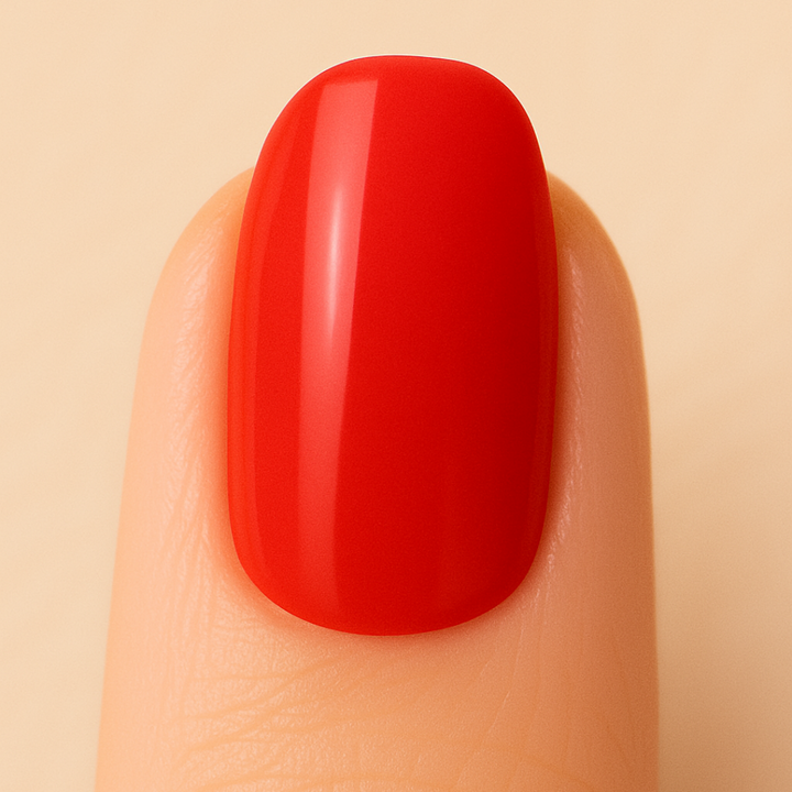 Orange gel polish painted on a nail against a beige background