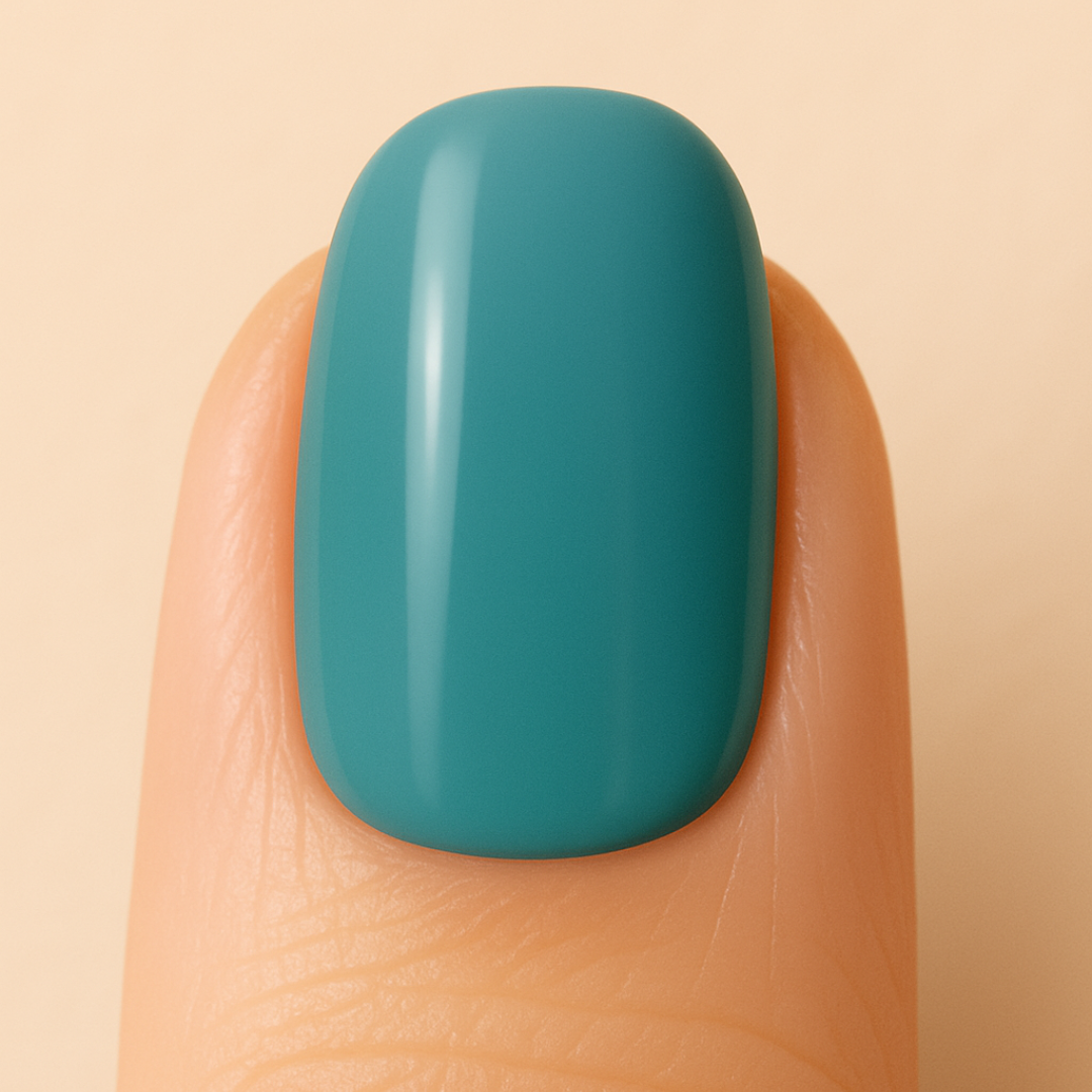 Petrol blue gel polish on a finger against a beige background