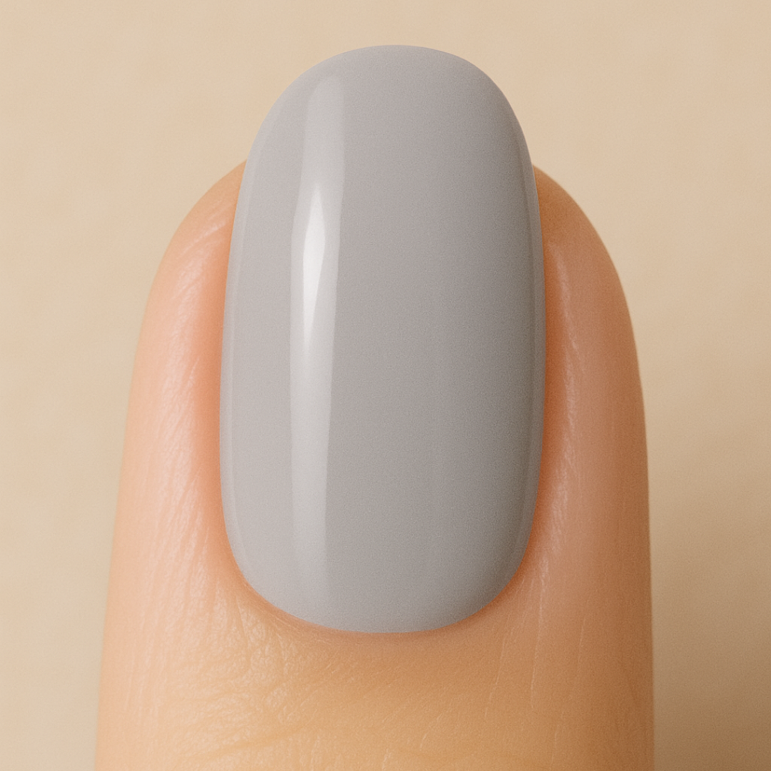Nail with silver gel polish on a beige background
