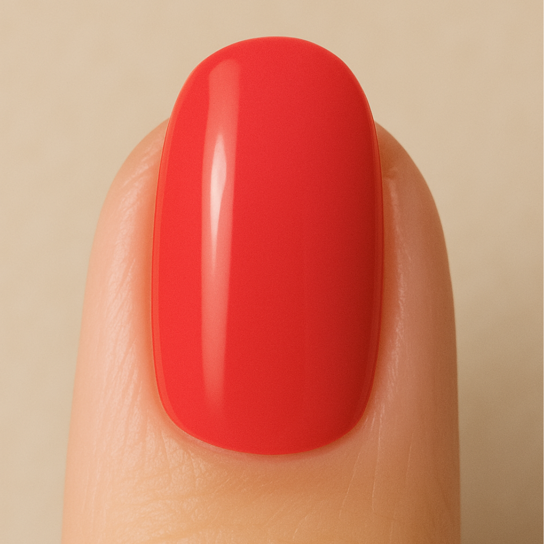 Red gel nail polish on a finger against a beige background